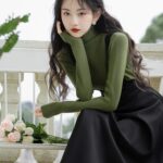 Dark-Academia-Women-in-Green-Sweater-Black-Suspender-Dress-Outfit (1)