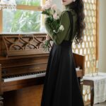 Dark-Academia-Women-in-Green-Sweater-Black-Suspender-Dress-Outfit (5)